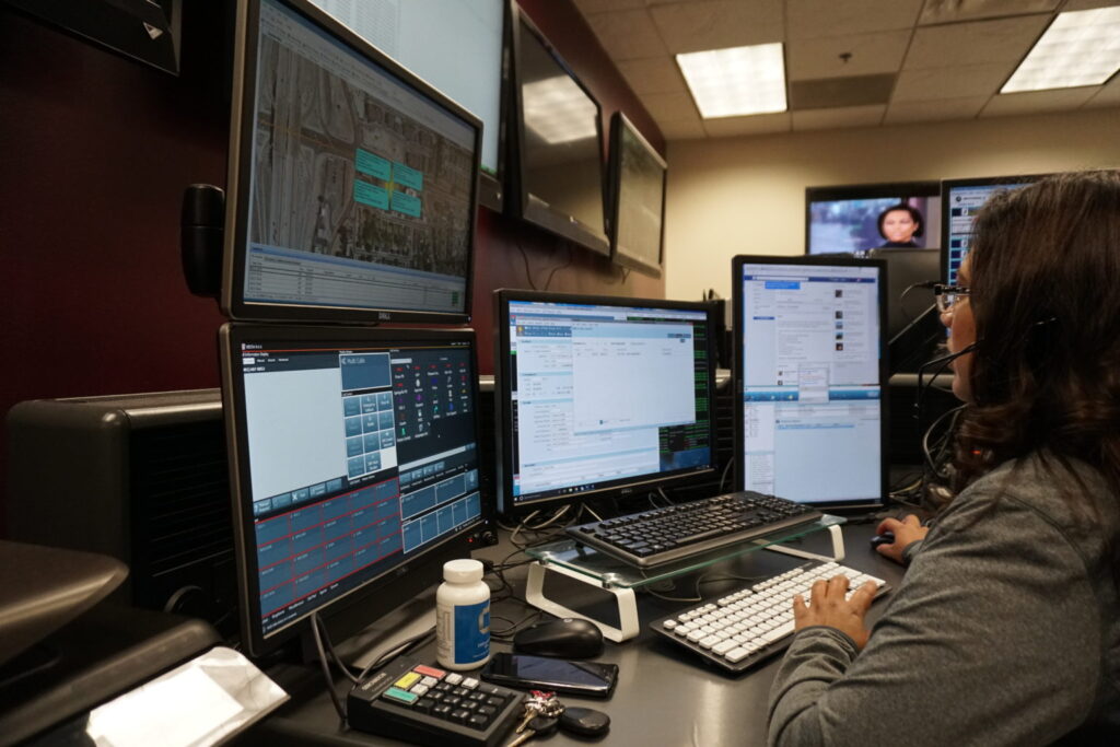 Picture of woman dispatcher on duty taking emergency calls