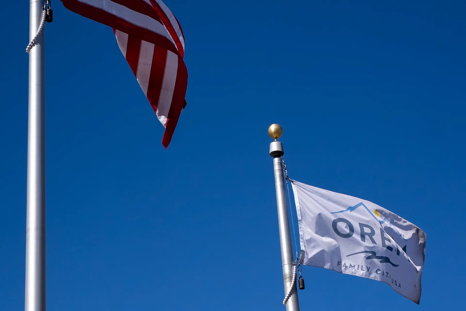The United States Flag next to the Orem City Flag.