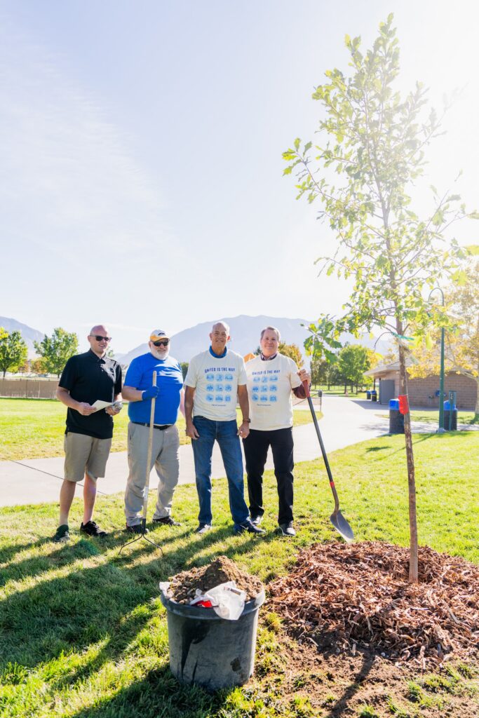 Chris Killpack planting trees with friends. 