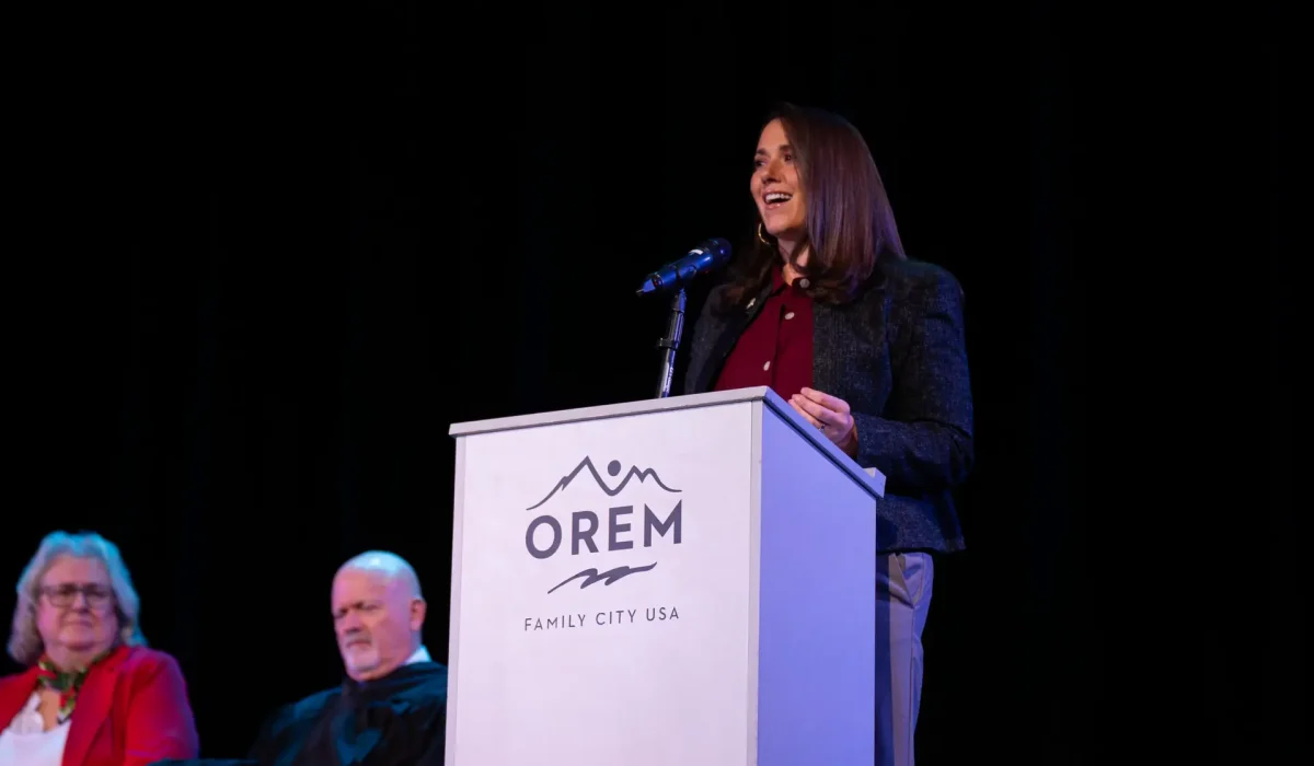 Crystal Muhlestein gives a speech at a podium